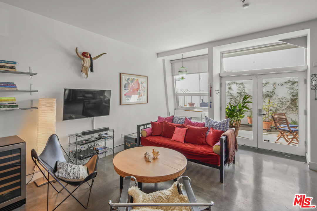 615 Hampton Drive, Unit A103 Venice, CA 90291 - Photo 16 of 20 a living room with furniture a flat screen tv and a window