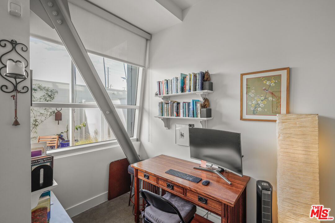 615 Hampton Drive, Unit A103 Venice, CA 90291 - Photo 17 of 20 a bedroom with a bed and a bookshelf