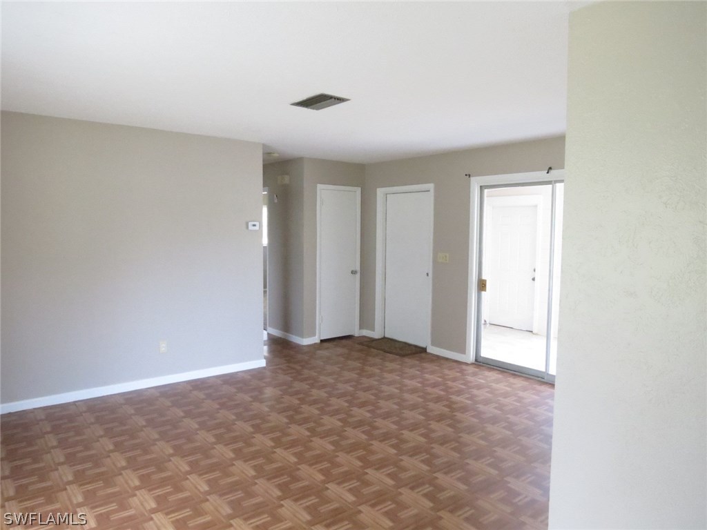 302 Penn Road West Lehigh Acres, FL 33936 - Photo 4 of 10 a view of an empty room and window