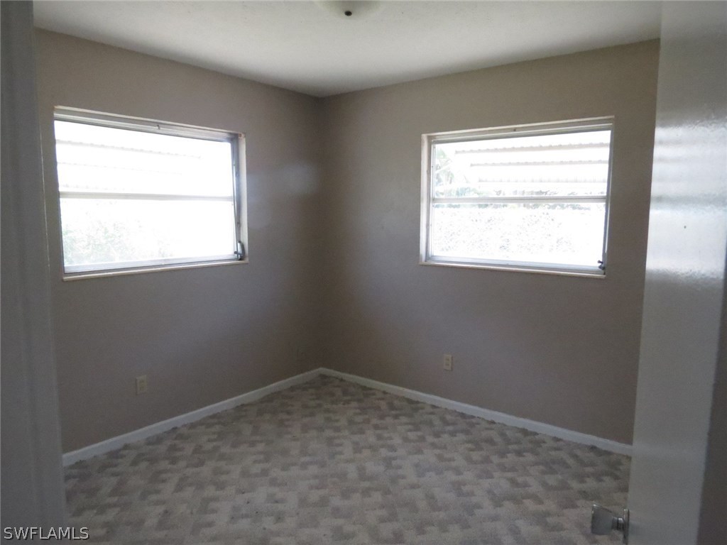 302 Penn Road West Lehigh Acres, FL 33936 - Photo 7 of 10 an empty room with a window