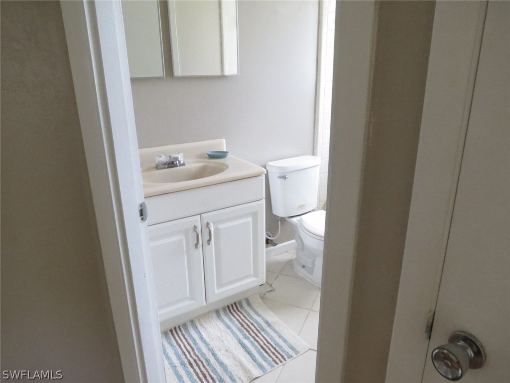 302 Penn Road West Lehigh Acres, FL 33936 - Photo 8 of 10 a bathroom with a sink and a toilet