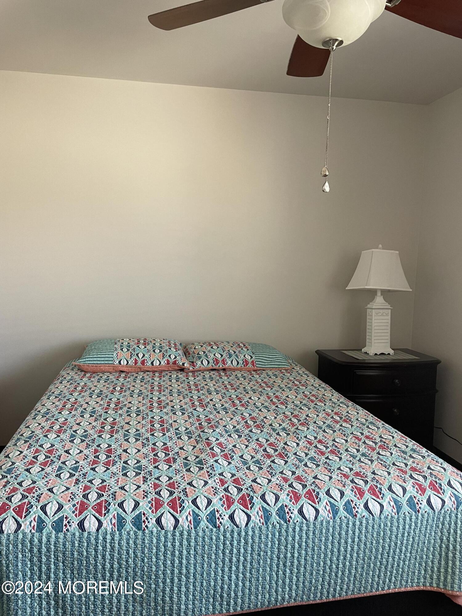 65 Grand Central Avenue Lavallette, NJ 08735 - Photo 7 of 15 a bedroom with a bed and a lamp