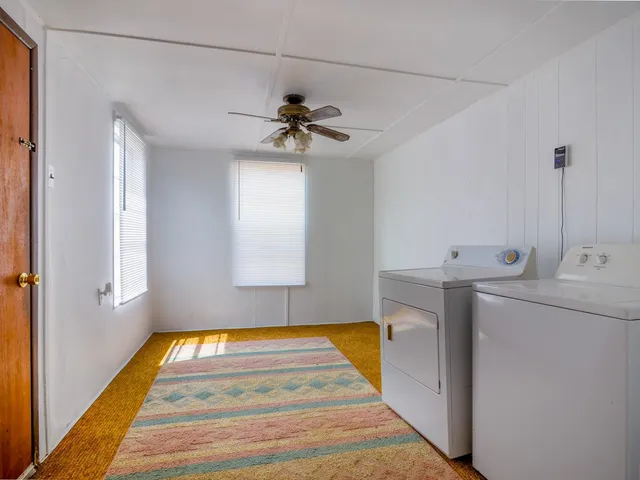 a kitchen with a stove a sink and a window