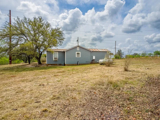 a view of house with a big yard