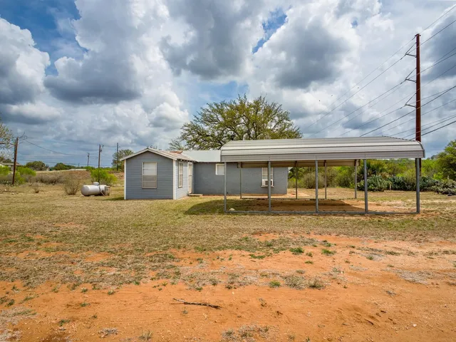 a view of a house with a yard and garage