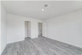 a view of an empty room and wooden floor