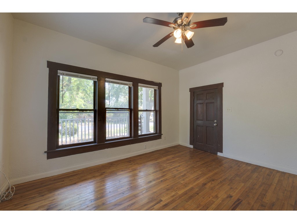 106 South Ave A, Unit A Elgin, TX 78621 - Photo 2 of 12 a view of an empty room with a window and a chandelier fan
