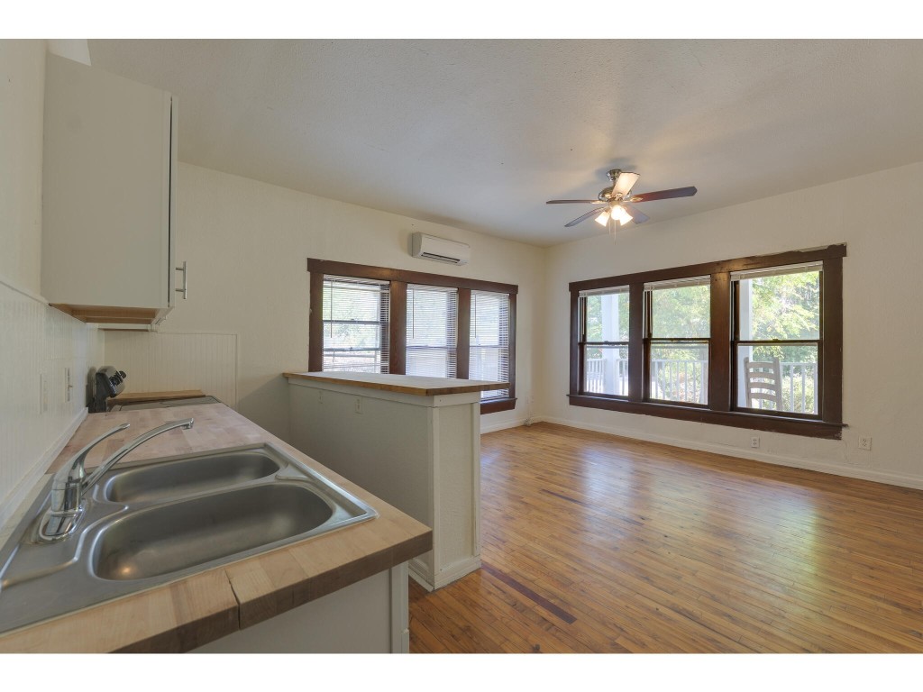 106 South Ave A, Unit A Elgin, TX 78621 - Photo 4 of 12 a view of livingroom and kitchen with hardwood floor