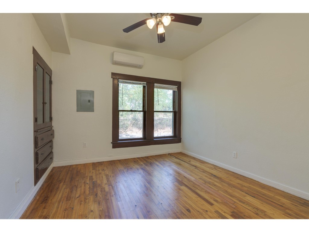 106 South Ave A, Unit A Elgin, TX 78621 - Photo 6 of 12 a view of an empty room with wooden floor and a window