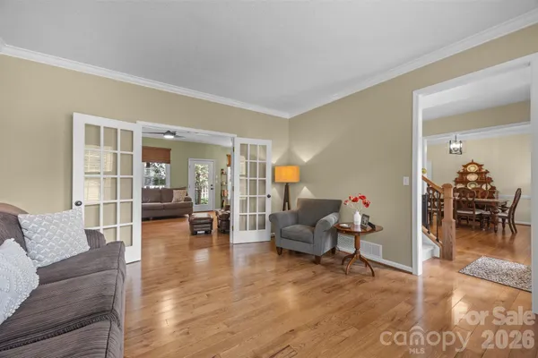 a living room with furniture and wooden floor