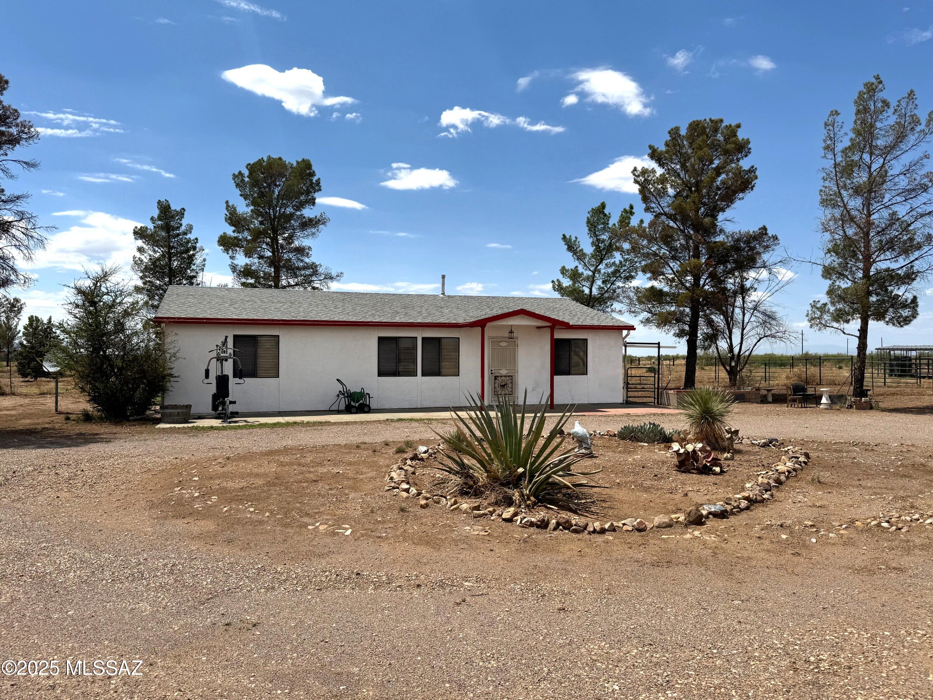 13384 South Cottonwood Road Pearce, AZ 85625 - Photo 1 of 46 a front view of a house with a yard and outdoor seating