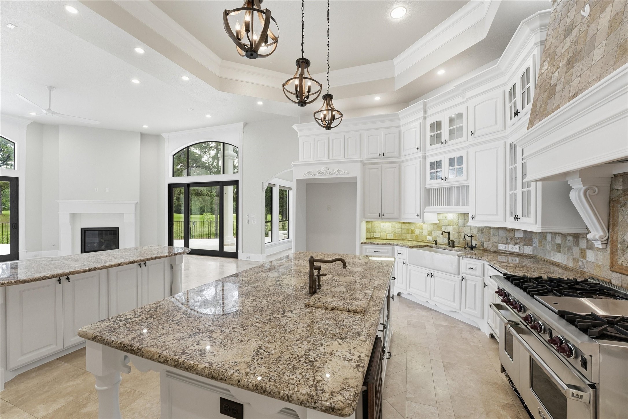 70 Quail Rock Place The Woodlands, TX 77381 - Photo 10 of 46 a kitchen with stainless steel appliances granite countertop a sink a stove and a wooden floors