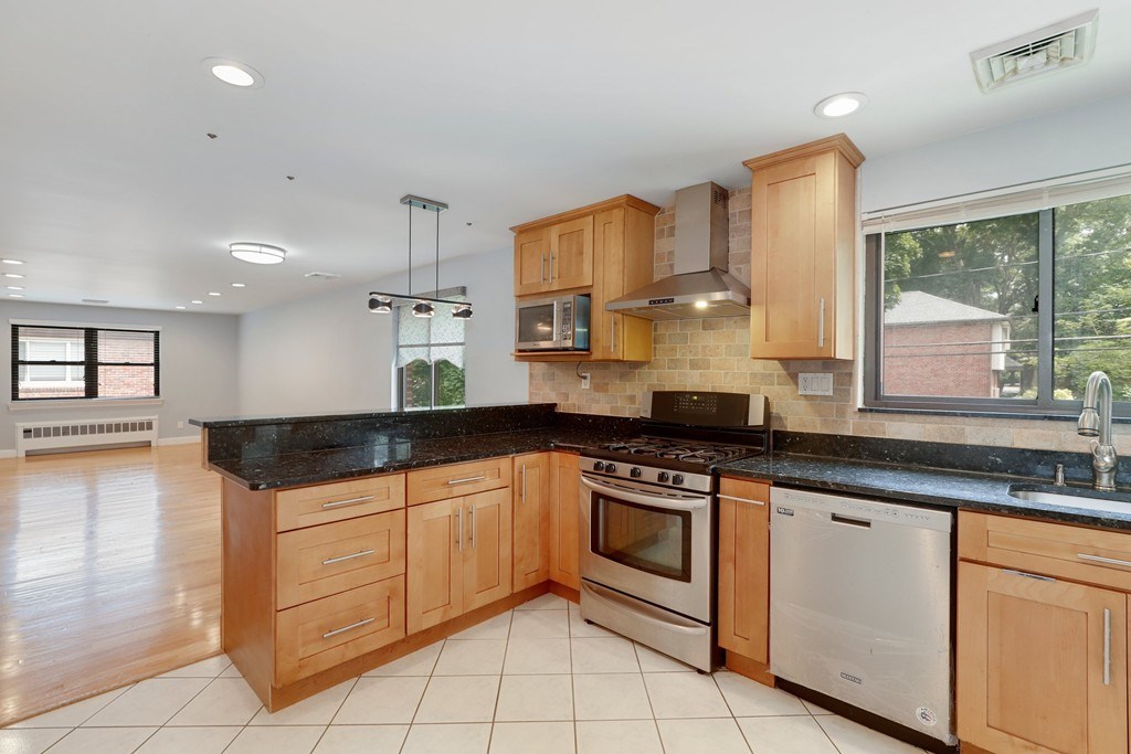37 Louise Road, Unit 37 Newton, MA 02467 - Photo 1 of 33 a kitchen with granite countertop a stove sink and cabinets