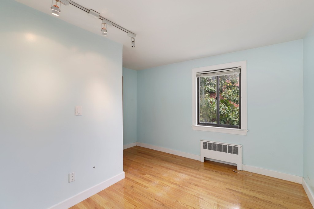 37 Louise Road, Unit 37 Newton, MA 02467 - Photo 13 of 33 a view of an empty room with wooden floor and a window