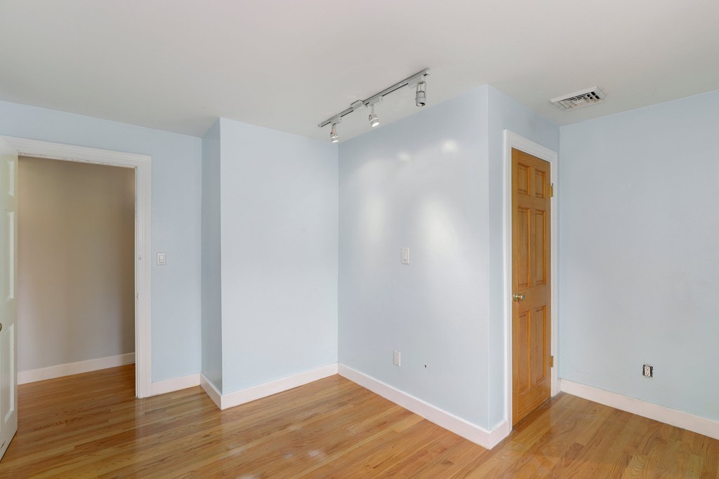 37 Louise Road, Unit 37 Newton, MA 02467 - Photo 14 of 33 a view of an empty room with wooden floor and closet