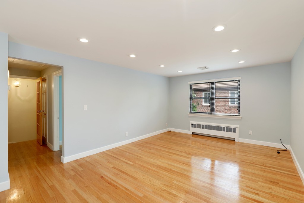 37 Louise Road, Unit 37 Newton, MA 02467 - Photo 15 of 33 a view of an empty room with wooden floor and a window