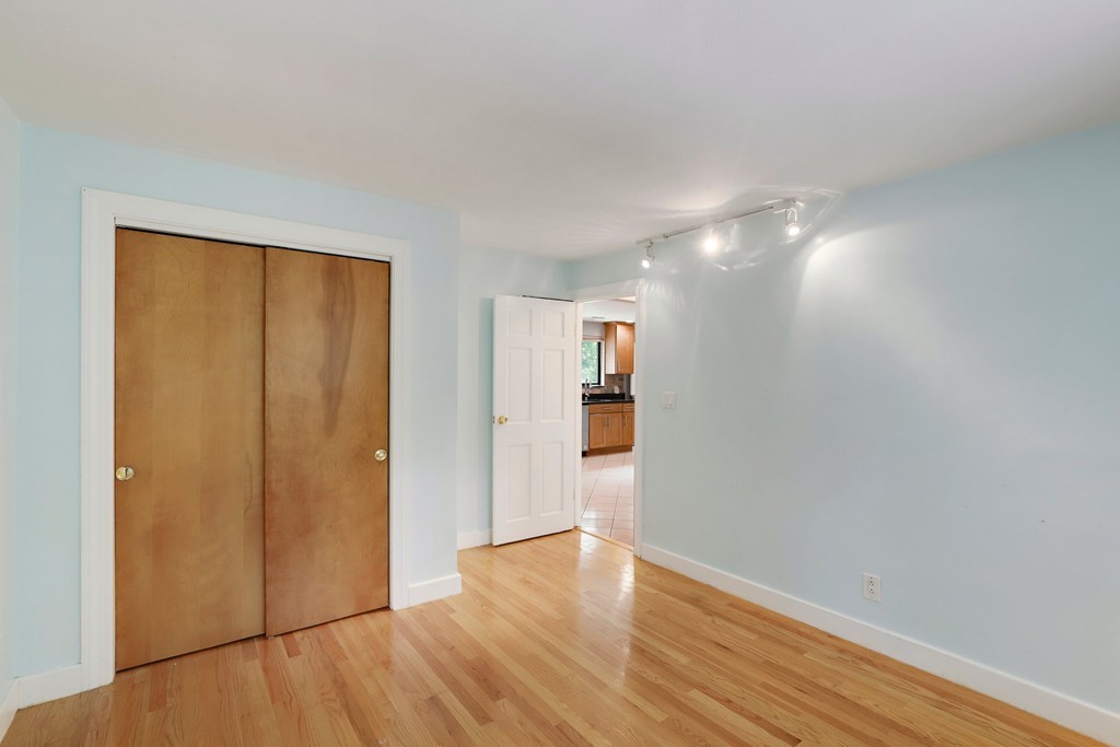 37 Louise Road, Unit 37 Newton, MA 02467 - Photo 17 of 33 a view of empty room with wooden floor