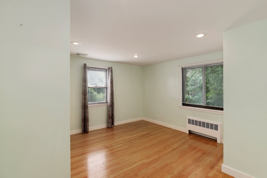 37 Louise Road, Unit 37 Newton, MA 02467 - Photo 20 of 33 a view of an empty room with wooden floor and a window