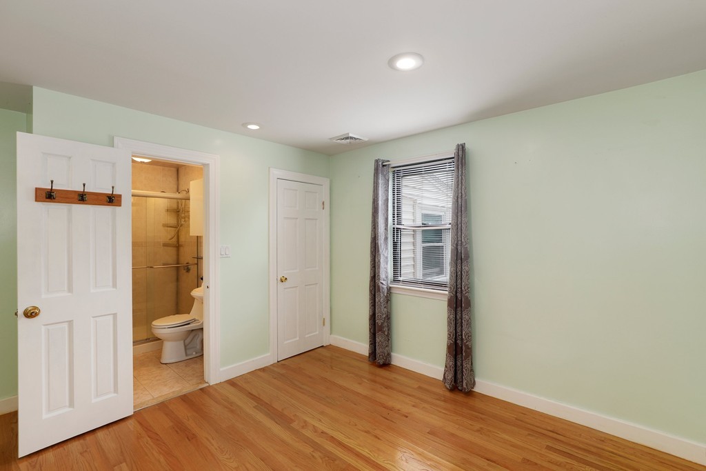 37 Louise Road, Unit 37 Newton, MA 02467 - Photo 24 of 33 a view of a bathroom with toilet window and wooden floor