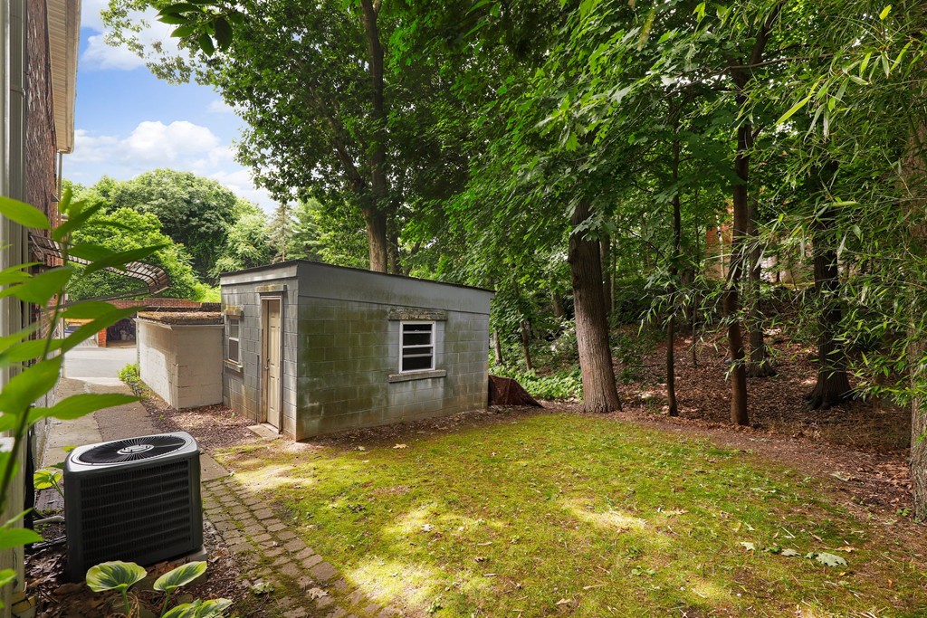 37 Louise Road, Unit 37 Newton, MA 02467 - Photo 31 of 33 a backyard of a house with barbeque oven and outdoor seating