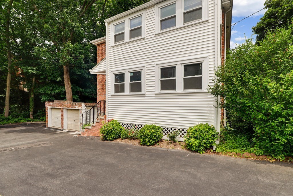 37 Louise Road, Unit 37 Newton, MA 02467 - Photo 4 of 33 a view of a house with a yard and garage