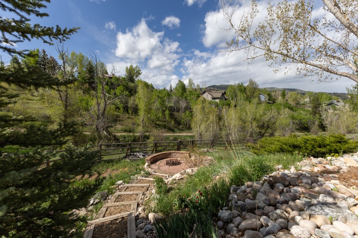 1215 Ridge View Drive Steamboat Springs, CO 80487 - Photo 27 of 30 Landscaped Yard Featuring Stone Fire Pit