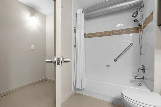 a bathroom with a bathtub shower sink vanity and a toilet