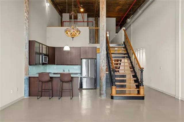 a view of kitchen with furniture and stairs