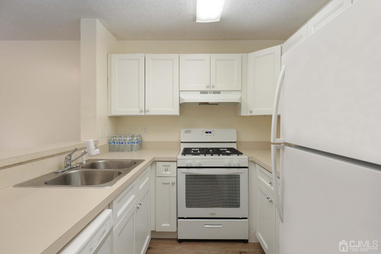 1026 Edpas Road New Brunswick, NJ 08901 - Photo 9 of 20 a kitchen with white cabinets sink and stainless steel appliances