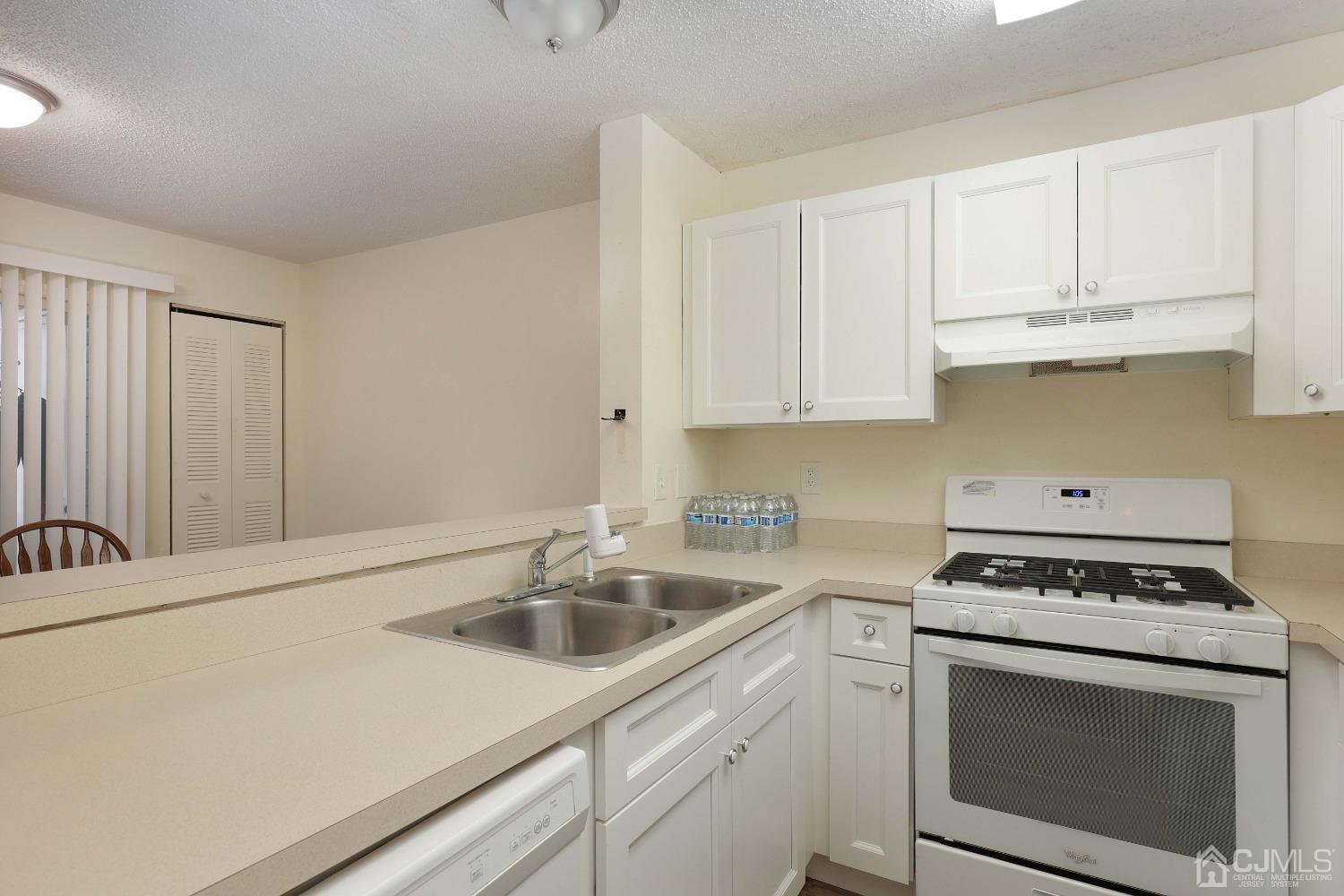 1026 Edpas Road New Brunswick, NJ 08901 - Photo 10 of 20 a kitchen with white cabinets sink and white appliances