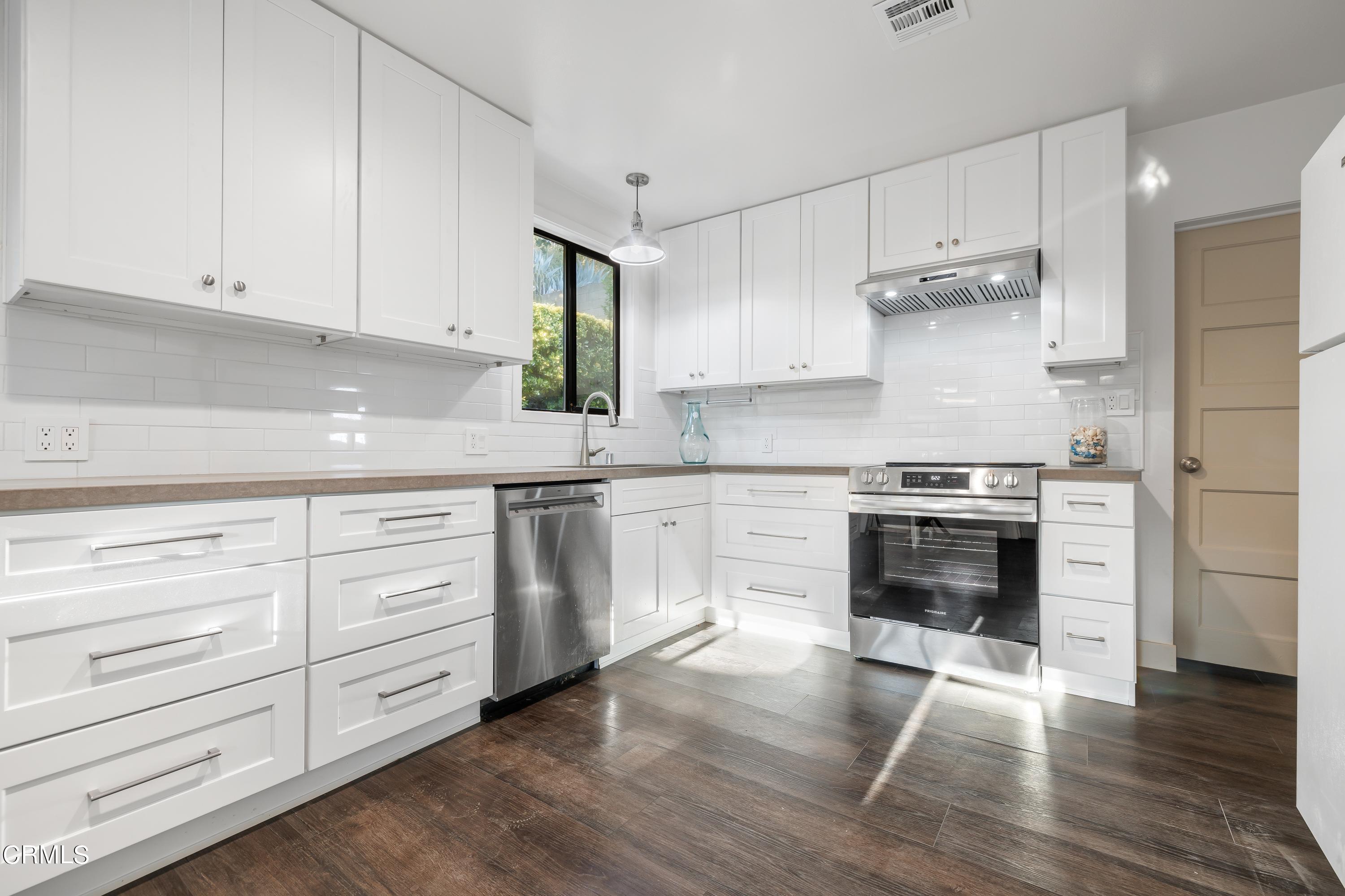 6463 Tokay Road Tujunga, CA 91042 - Photo 12 of 23 a kitchen with granite countertop a sink cabinets and stainless steel appliances