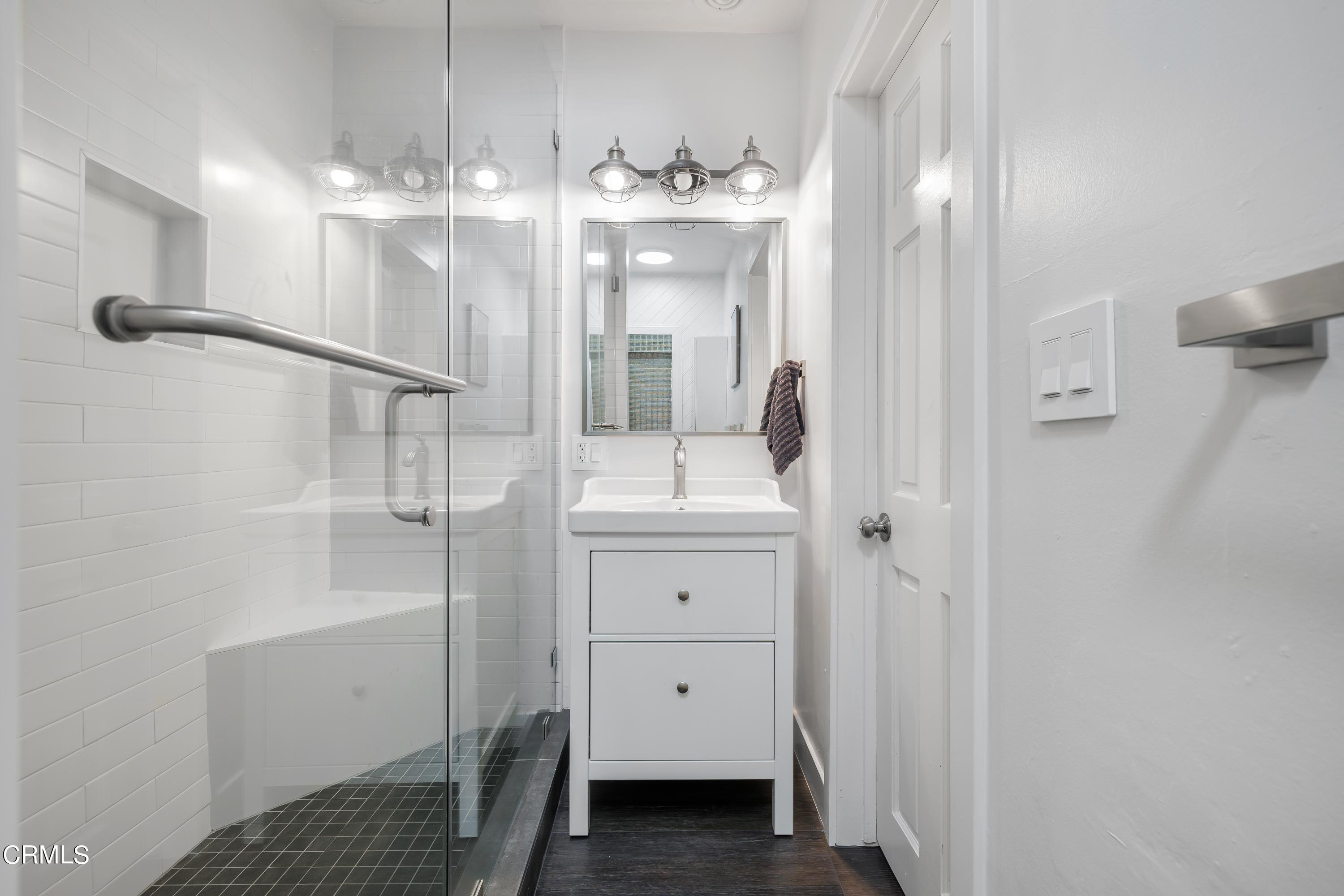 6463 Tokay Road Tujunga, CA 91042 - Photo 15 of 23 a bathroom with a sink a light fixture and a mirror