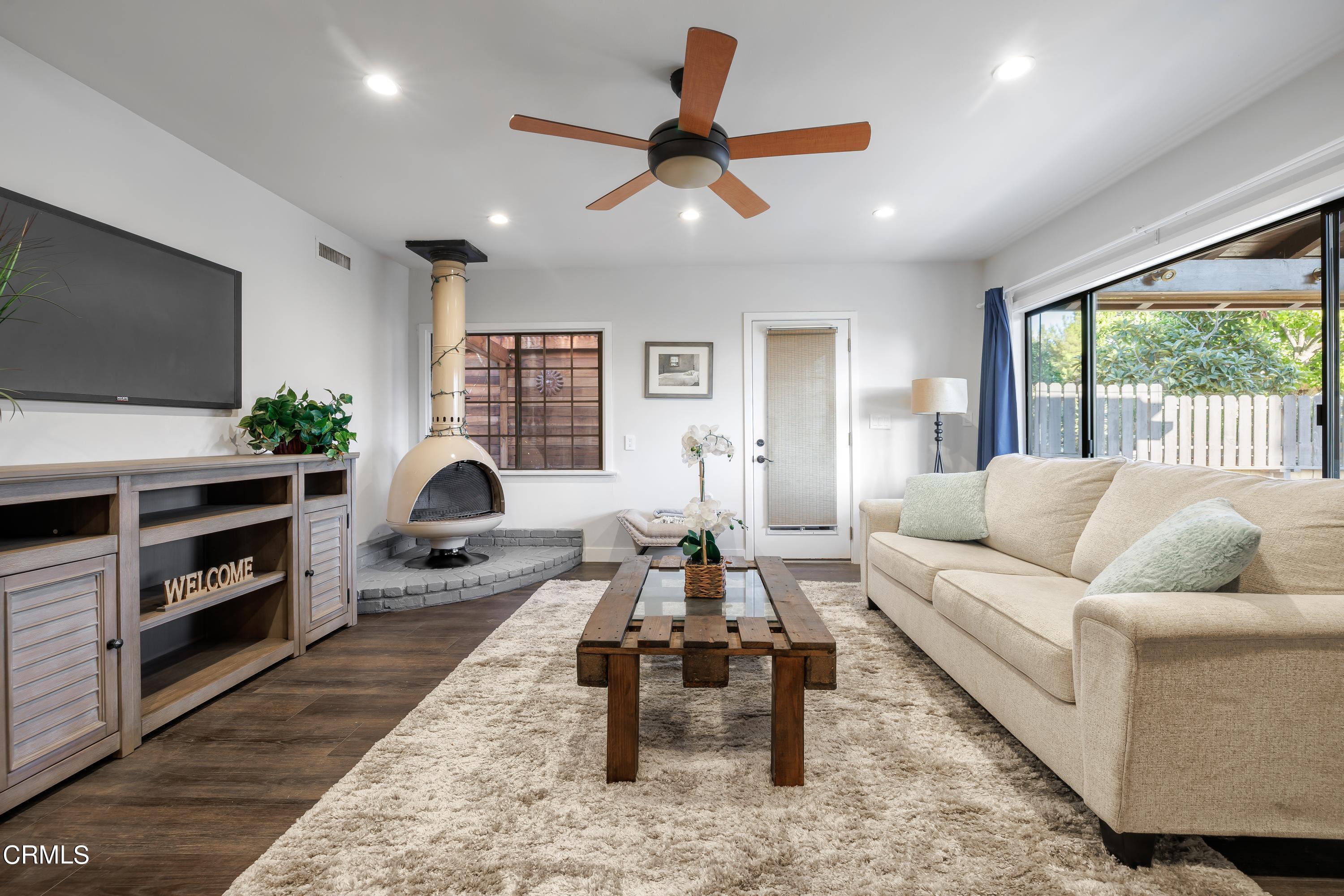 6463 Tokay Road Tujunga, CA 91042 - Photo 8 of 23 a living room with furniture fireplace and a flat screen tv