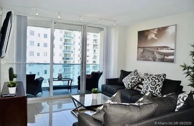 a living room with furniture and large window