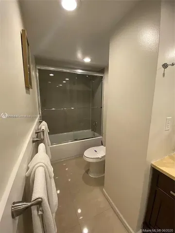 a bathroom with a shower a toilet and sink