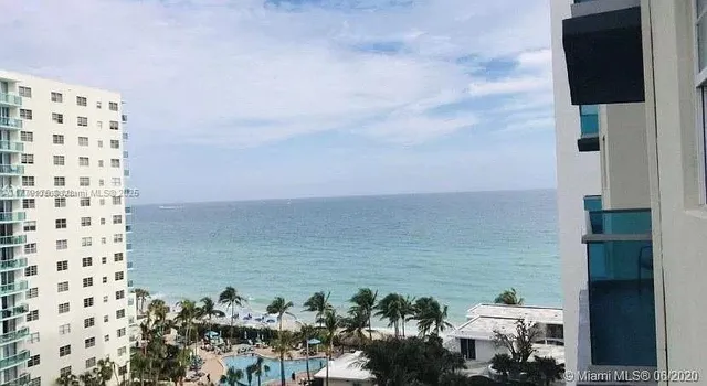 a view of a terrace with lawn chairs