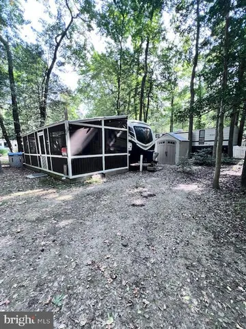 a backyard of a house with barbeque oven table and chairs