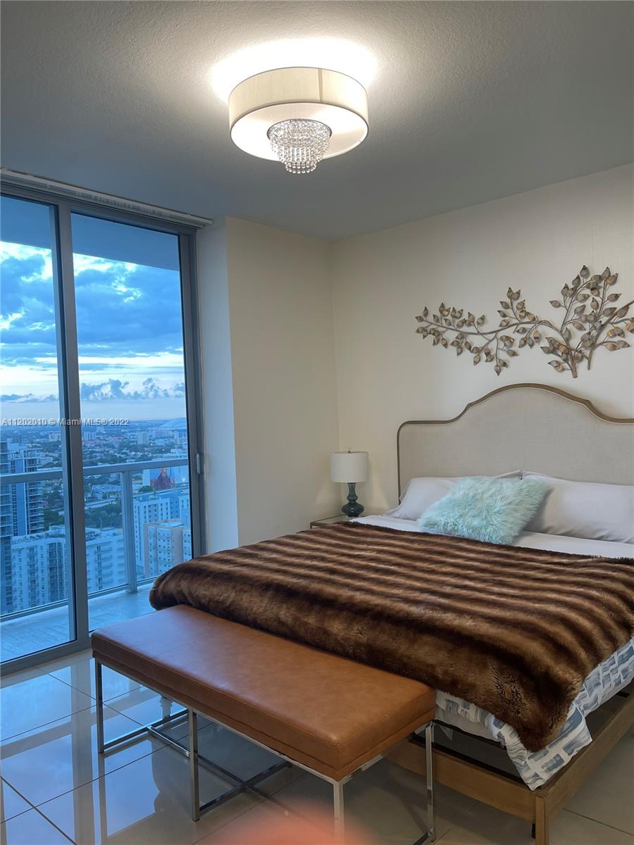 Brickell Miami, FL 33130 - Photo 12 of 30 a bedroom with a bed and a table