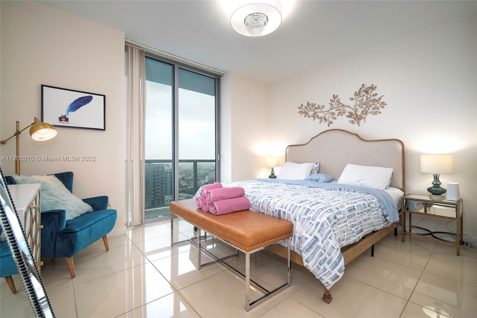 Brickell Miami, FL 33130 - Photo 13 of 30 a bedroom with a bed and wooden floor