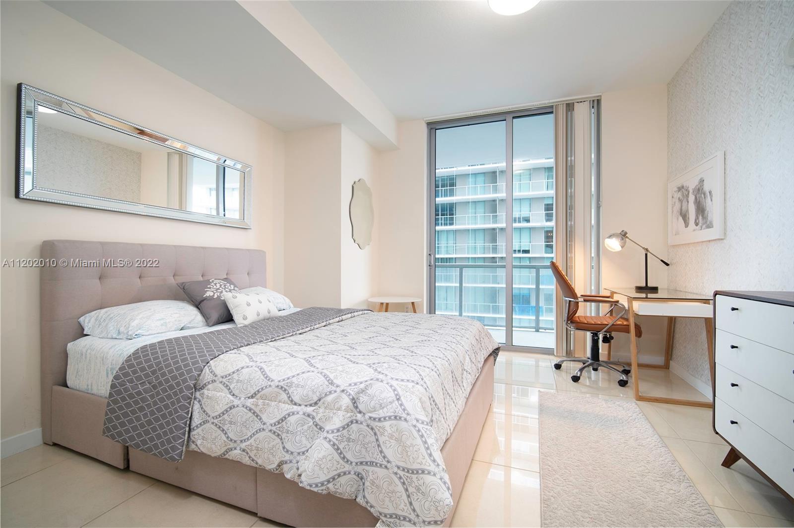 Brickell Miami, FL 33130 - Photo 17 of 30 a bedroom with a large bed and a window