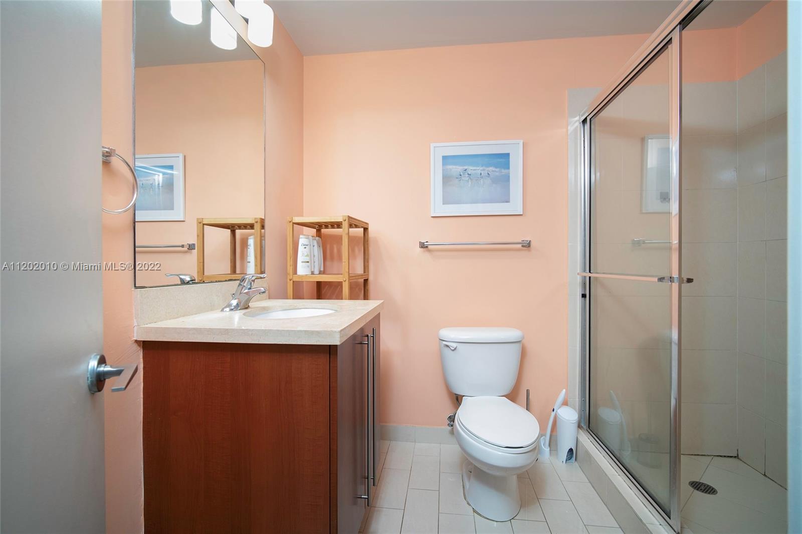 Brickell Miami, FL 33130 - Photo 19 of 30 a bathroom with a toilet a sink and mirror