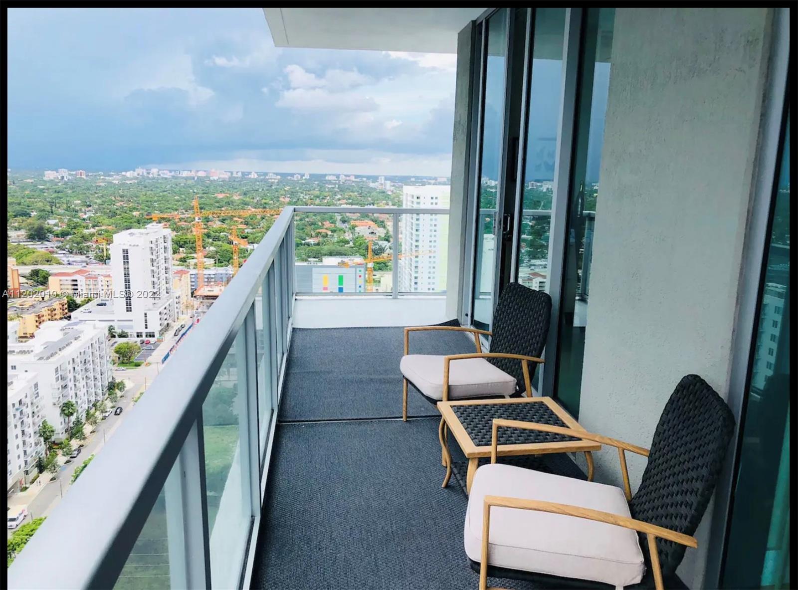 Brickell Miami, FL 33130 - Photo 21 of 30 a room with furniture and a window
