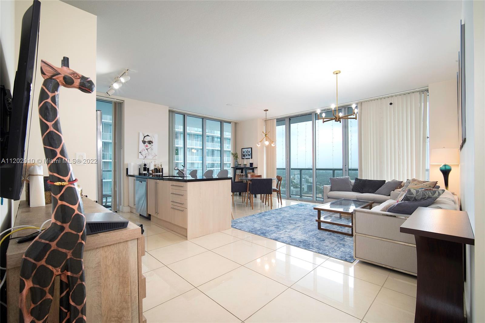 Brickell Miami, FL 33130 - Photo 3 of 30 a living room with furniture and a flat screen tv