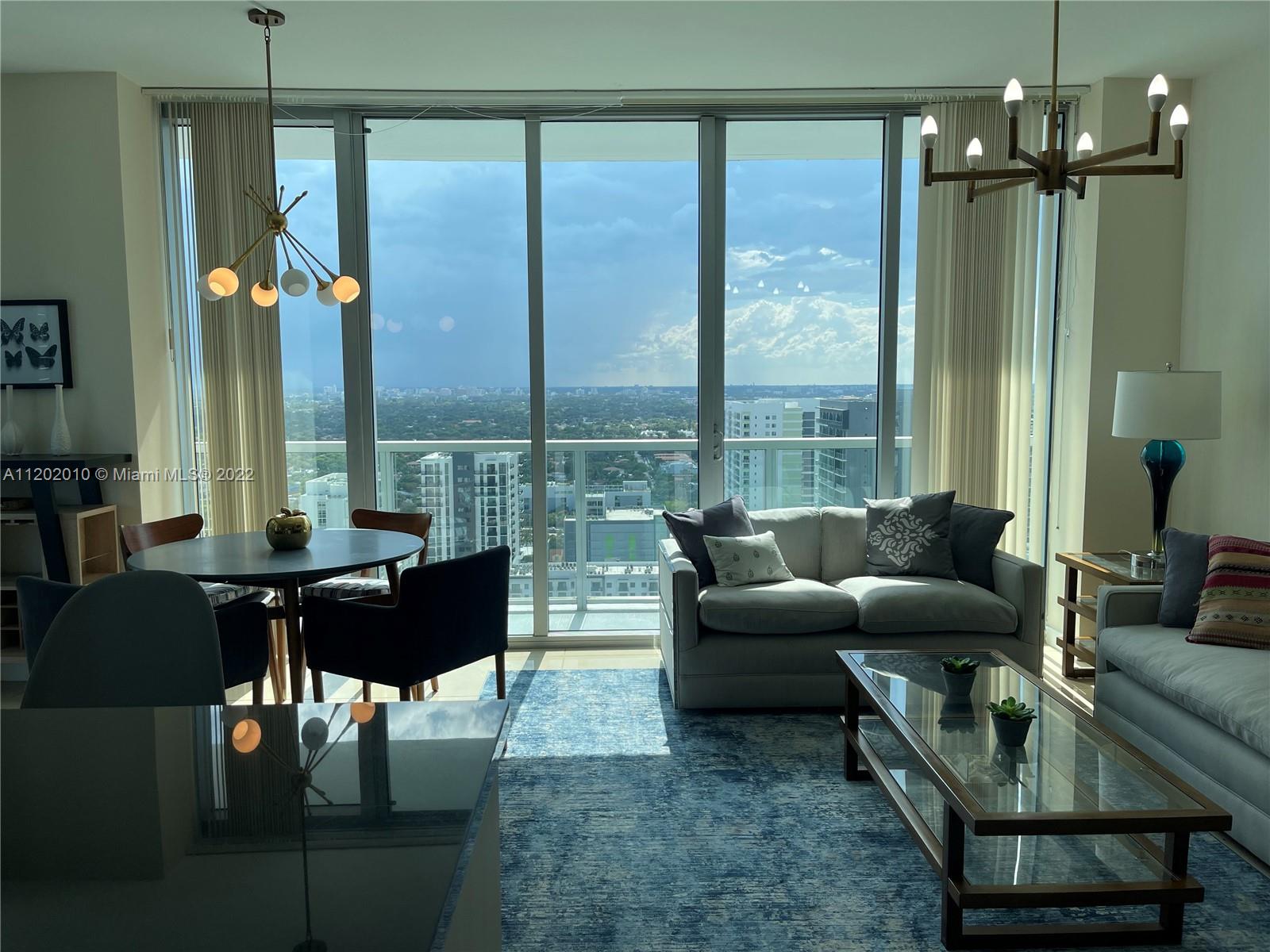 Brickell Miami, FL 33130 - Photo 7 of 30 a living room with furniture and a large window