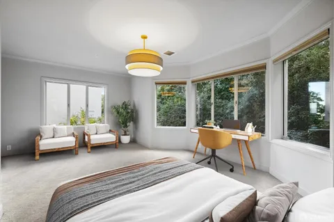 a bedroom with a bed and a lounge chair