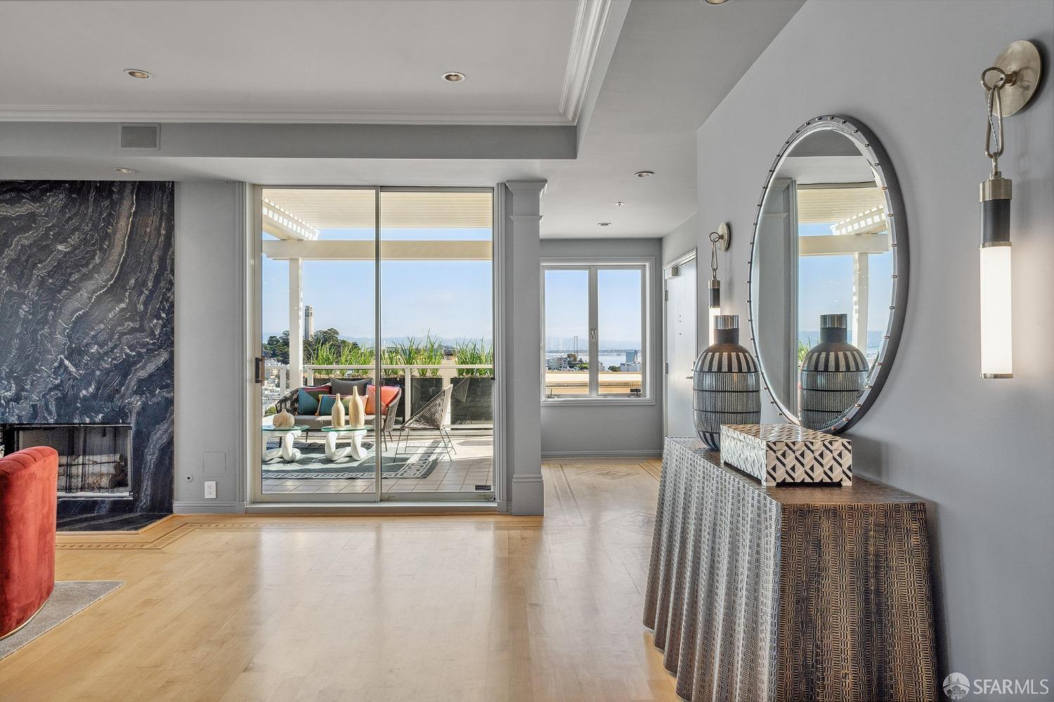 900 Green Street, Unit 600 San Francisco, CA 94133 - Photo 22 of 50 a view of a hallway with wooden floor and a fireplace