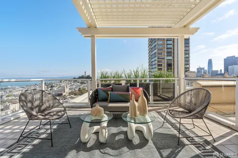 a living room with furniture and a floor to ceiling window