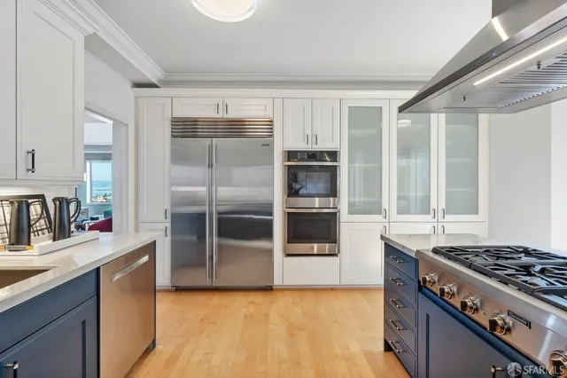 a kitchen with granite countertop a sink cabinets and stainless steel appliances