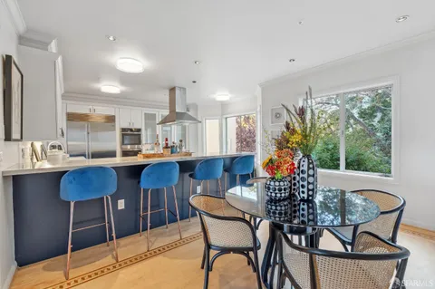 a dining room with furniture and wooden floor