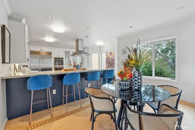 a dining room with furniture and wooden floor